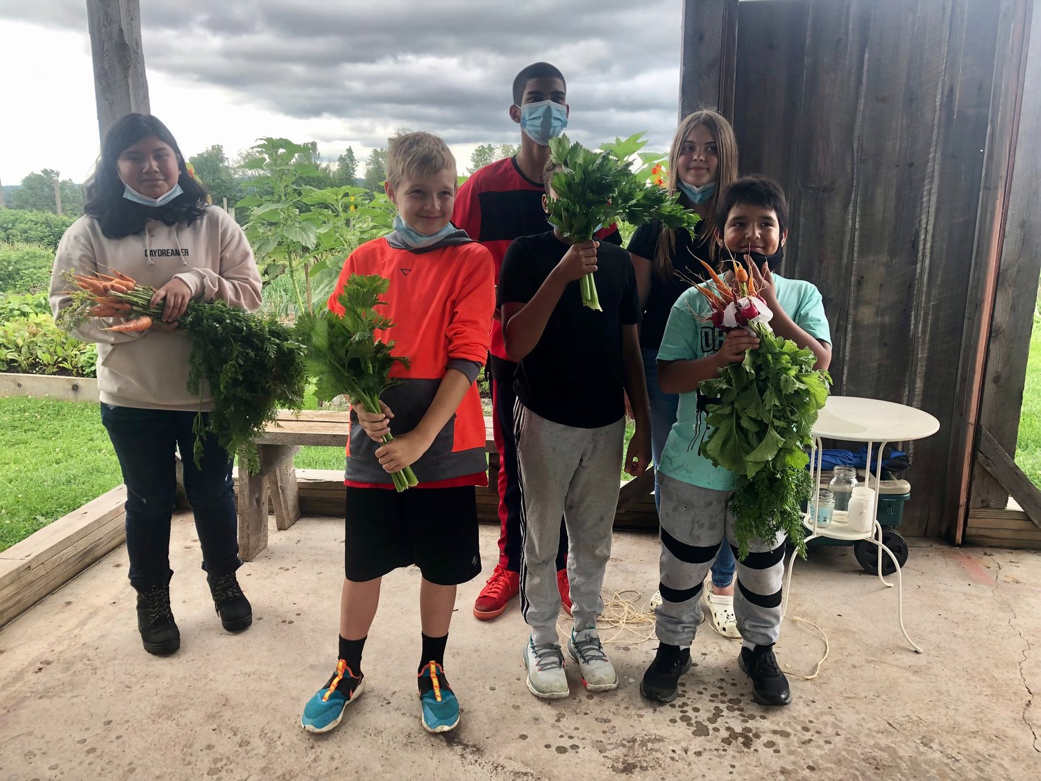 Students from the Liberty Partnership Program show off their harvest, which they cooked into a farm-to-table lunch with SUNY Sullivan’s culinary instructors.